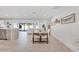 Bright dining area with a wood table and four beige chairs, open to the kitchen and living room at 8430 E Fairmount Ave, Scottsdale, AZ 85251