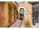 Stone pathway with a trellis and lush greenery at 1036 E Sahuaro Dr, Phoenix, AZ 85020