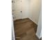 Bright hallway with wood-look flooring and white door at 25258 W Bowker St, Buckeye, AZ 85326