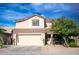 Two-story house with tan exterior and a two car garage at 29101 N Yellow Bee Dr, San Tan Valley, AZ 85143