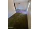 Carpeted living room area with a view to another room at 5937 W Coolidge St, Phoenix, AZ 85033