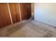 Bedroom with double door closet and carpeted floors at 5937 W Coolidge St, Phoenix, AZ 85033