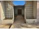 Front entry with decorative concrete block walls and a stone pathway at 5937 W Coolidge St, Phoenix, AZ 85033