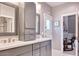 Modern bathroom with gray cabinets and double sinks at 7101 E Berneil Ln, Paradise Valley, AZ 85253