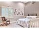 Cozy bedroom with a rocking chair and plenty of natural light at 7101 E Berneil Ln, Paradise Valley, AZ 85253