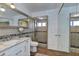 Elegant bathroom with a walk-in shower, large mirror and white vanity at 4525 N 66Th St # 48, Scottsdale, AZ 85251
