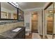 Modern bathroom with a walk-in shower, dark vanity, and tiled floors at 4525 N 66Th St # 48, Scottsdale, AZ 85251