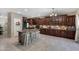 Modern kitchen featuring dark wood cabinets and a granite island at 7715 S 69Th Ln, Laveen, AZ 85339