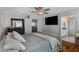 Bright bedroom with a large bed and ensuite bathroom at 7715 S 69Th Ln, Laveen, AZ 85339