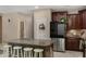 Granite kitchen island with seating, stainless steel appliances and dark cabinetry at 7715 S 69Th Ln, Laveen, AZ 85339