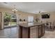 Open kitchen with an island, stainless steel appliances and backyard access at 7715 S 69Th Ln, Laveen, AZ 85339