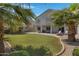 Backyard view showcasing a grassy lawn and covered patio at 7715 S 69Th Ln, Laveen, AZ 85339