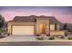 Tan house with tile roof, garage, and landscaping at 7691 W Cactus Wren Way, Florence, AZ 85132