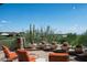 Stone patio with orange chairs, offering scenic views at 10626 E Palo Brea Dr, Scottsdale, AZ 85262