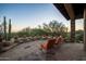 Peaceful patio with a stone floor and sunset view at 10626 E Palo Brea Dr, Scottsdale, AZ 85262