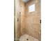 Large walk-in shower with beige tile and glass enclosure at 10626 E Palo Brea Dr, Scottsdale, AZ 85262