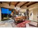 Spacious home office with wood desk, stone accents, and backyard views at 10626 E Palo Brea Dr, Scottsdale, AZ 85262