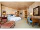 Spacious bedroom with a king-size bed and a built-in desk at 10626 E Palo Brea Dr, Scottsdale, AZ 85262