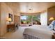 Bedroom with views of the golf course and patio at 10626 E Palo Brea Dr, Scottsdale, AZ 85262