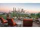 Evening view of patio with chairs and desert landscape at 10626 E Palo Brea Dr, Scottsdale, AZ 85262