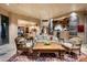 Open living room with stone accents, comfortable seating, and views at 10626 E Palo Brea Dr, Scottsdale, AZ 85262