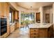 Gourmet kitchen boasts wood cabinets, granite counters, and island at 10626 E Palo Brea Dr, Scottsdale, AZ 85262