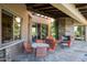 Outdoor patio with seating, stone fireplace, and bar at 10626 E Palo Brea Dr, Scottsdale, AZ 85262