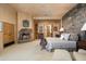 Main bedroom with stone fireplace and views of backyard at 10626 E Palo Brea Dr, Scottsdale, AZ 85262