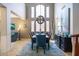 An elegant dining room with a large table, globe chandelier, and high ceilings at 161 N Silverwood Dr, Casa Grande, AZ 85122