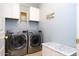 Laundry room with washer, dryer, and cabinets at 161 N Silverwood Dr, Casa Grande, AZ 85122