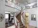 A stunning curved staircase with wooden railings, offering a view to the living room at 161 N Silverwood Dr, Casa Grande, AZ 85122