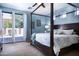 Spacious main bedroom with pool view and four-poster bed at 161 N Silverwood Dr, Casa Grande, AZ 85122