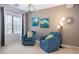 A relaxing sitting area featuring two blue armchairs, and tasteful wall art at 161 N Silverwood Dr, Casa Grande, AZ 85122