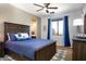 Blue and gray bedroom with a wooden bed frame at 161 N Silverwood Dr, Casa Grande, AZ 85122