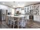 Modern kitchen with white cabinets, granite island, and stainless steel appliances at 161 N Silverwood Dr, Casa Grande, AZ 85122