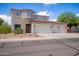 Two-story house with three-car garage, stone accents, and desert landscaping at 161 N Silverwood Dr, Casa Grande, AZ 85122