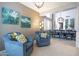 A sitting area with two armchairs, decorative pillows, and a view into the dining room at 161 N Silverwood Dr, Casa Grande, AZ 85122