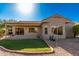 Home exterior showcasing a covered patio and grassy backyard at 19601 N Papago Dr, Surprise, AZ 85374