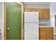 Green pantry door and white refrigerator at 535 S Alma School Rd # 45, Mesa, AZ 85210