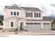 Two-story house with gray siding, stone accents, and a three-car garage at 12325 W Marguerite Ave, Avondale, AZ 85323