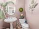 Charming powder room with pedestal sink and decorative accents at 9576 W Blue Sky Dr, Peoria, AZ 85383