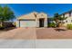 Tan two-story house with a two-car garage and landscaped yard at 17986 W Fulton St, Goodyear, AZ 85338