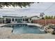 Inviting backyard oasis with a sparkling pool and a calming rock waterfall feature at 2124 E Osborn Rd, Phoenix, AZ 85016