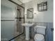 Bathroom highlighting a pedestal sink, toilet, and a shower with a glass door at 2124 E Osborn Rd, Phoenix, AZ 85016