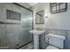Bathroom showcasing a pedestal sink, toilet, and shower with a glass door at 2124 E Osborn Rd, Phoenix, AZ 85016