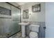 Bathroom with a pedestal sink, toilet, and a shower with a glass door at 2124 E Osborn Rd, Phoenix, AZ 85016