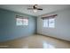 Bedroom with wood-look flooring, two windows, and light blue walls at 2124 E Osborn Rd, Phoenix, AZ 85016