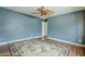 Empty bedroom with blue walls, wood floors, and ceiling fan at 2124 E Osborn Rd, Phoenix, AZ 85016
