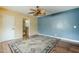 Bedroom with blue walls, wood floors, ceiling fan, and attached bathroom at 2124 E Osborn Rd, Phoenix, AZ 85016