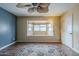 Bedroom featuring a ceiling fan, wood floors, and a bay window with sitting area at 2124 E Osborn Rd, Phoenix, AZ 85016